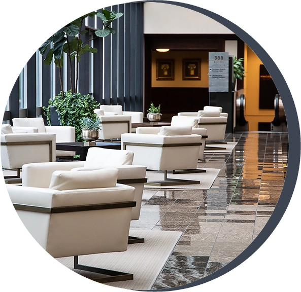 A group of white chairs in an indoor area.